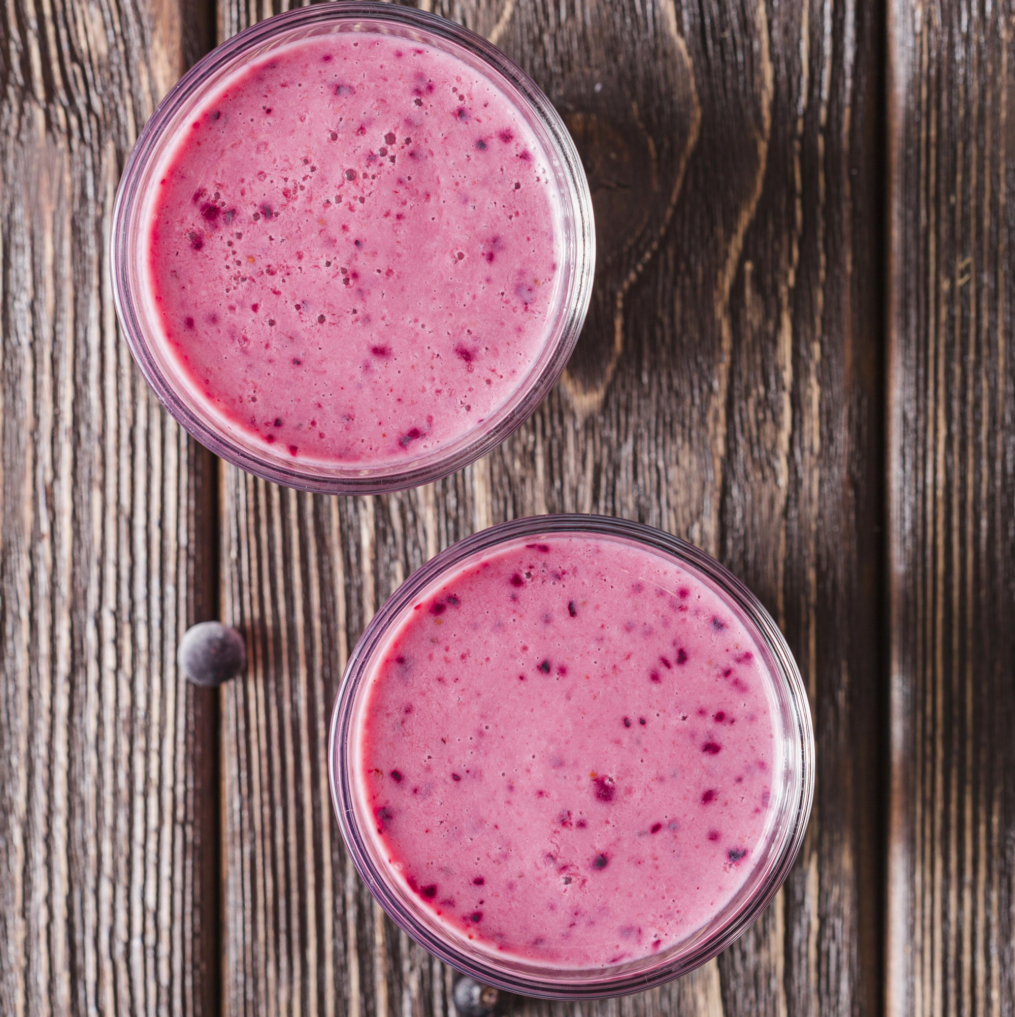top-view-pink-smoothie-glasses-with-blueberries